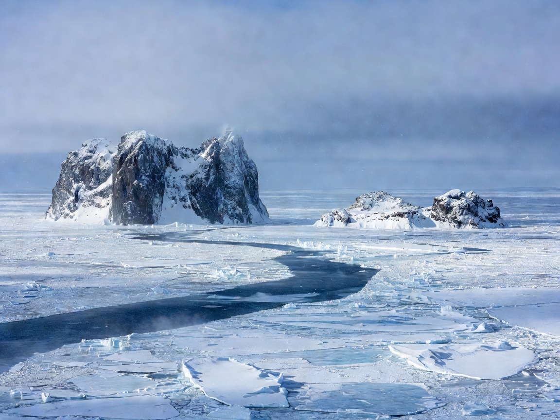 Frozen Arctic ocean waters and rocky island cliffs in the Bering Strait