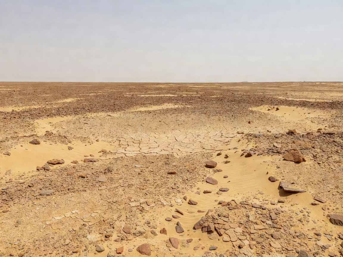 Arid desert dunes and rocky plateaus representing unclaimed Bir Tawil